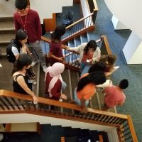 Library patrons walking down the stairs near the Sunken Reading Room.