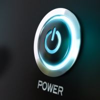 Finger  moving toward a power button with power symbol