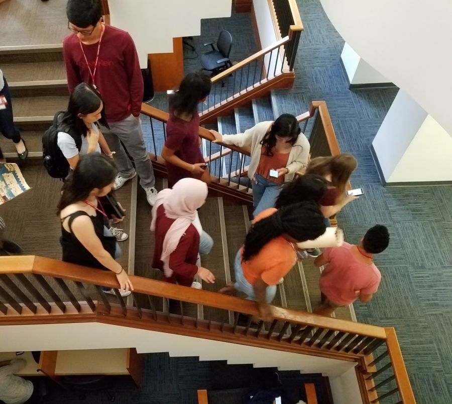 Library patrons walking down the stairs near the Sunken Reading Room.