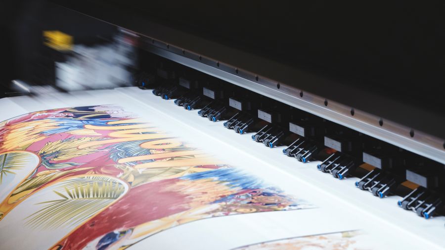 Professional printing machine printing a colorful document.