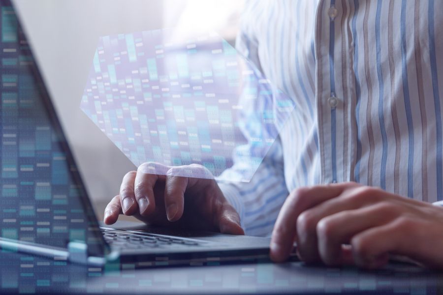 Person on a laptop with bioinformatics data being displayed