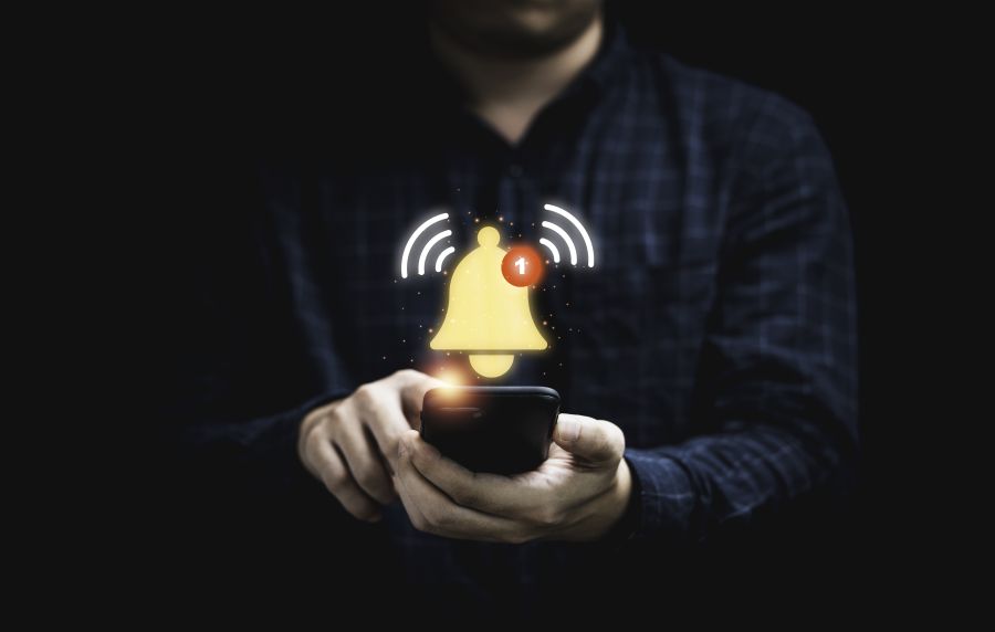 Man holding cell phone that is getting notifications