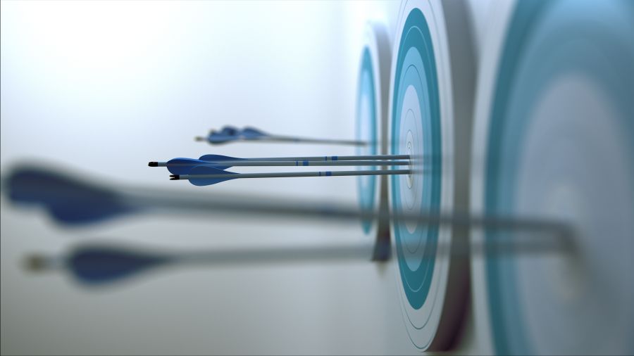 Multiple archery targets with arrows in them