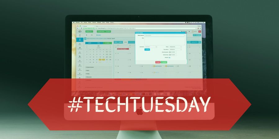 A computer monitor with a large banner in front that reads "#techtuesday"