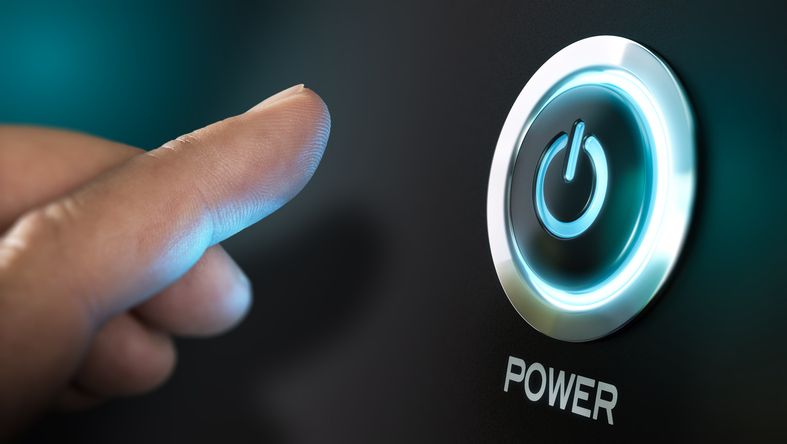 Finger moving toward a power button with power symbol