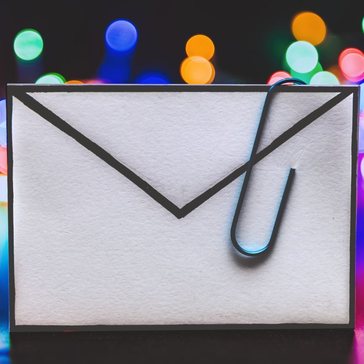 An email letter icon with a paperclip attached to it.